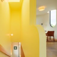 Yellow stairwell with skylight in Los Angeles ADU