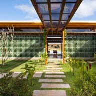 Jurumirim House by Nitsche Arquitetos features wall of perforated green blocks