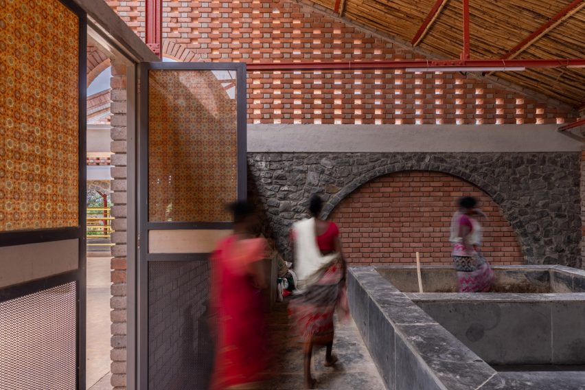 People walking around brick cow shed by Compartment S4