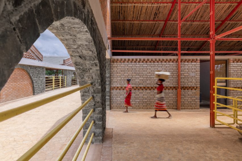 Red steel and stone structure of the cow house by Compartment S4