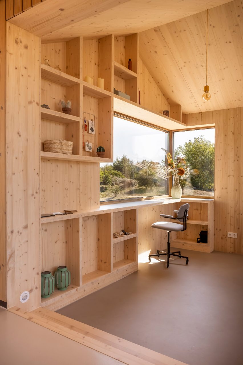 A wooden office with windows.
