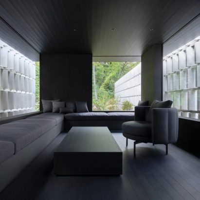 Angled concrete blocks screen home in Japanese forest by Nendo